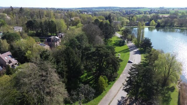 Drone view of a beautiful park and water pond in Brussels in a calm spring maring