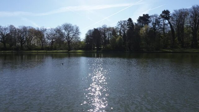 Drone view of a beautiful park and water pond in Brussels in a calm spring light
