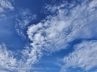white clouds in a clear blue sky