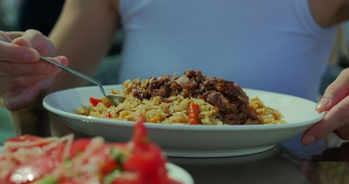 Woman Eating Traditional Uzbek Plov