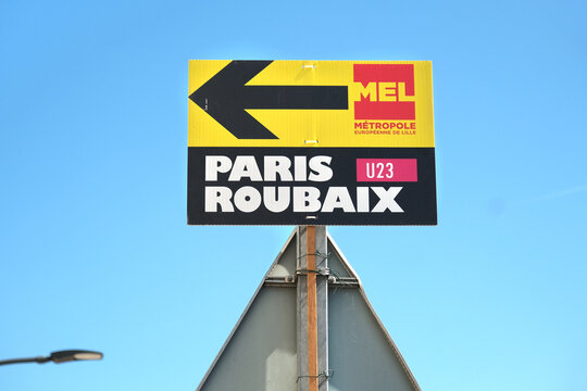 Wallers, France - 04 11 2025 : Directional signs for the Paris-Roubaix U23 cycling race in a quaint European village under a clear blue sky.