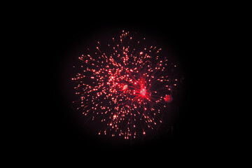 Red Firework Explosion Against Dark Night Sky