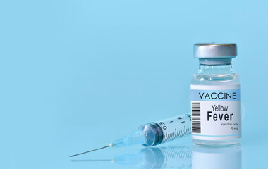 Vaccine in a bottle with a syringe on a blue background.The conc