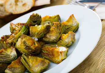 Appetizing artichokes fried in oil