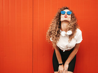 Beautiful smiling model with afro curls hairstyle dressed in summer hipster clothes. Sexy carefree...