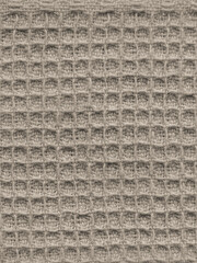 Close-up of beige waffle weave fabric texture.