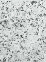 Close-up of weathered and textured concrete surface with spots
