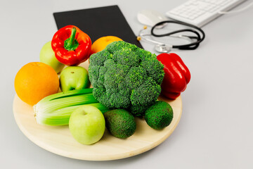 Organic healthy food with a medical stethoscope on a nutritionist's desk close-up. The concept of healthy eating.
