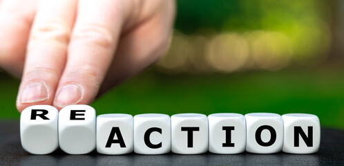 Hand turns dice and changes the word action to reaction. 