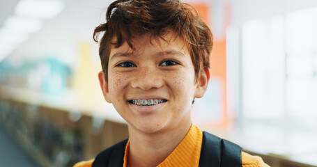 Portrait, education and boy with braces, student and confidence with smile, knowledge and learning academy. Face, happy kid and childhood with backpack, studying opportunity and campus with pride