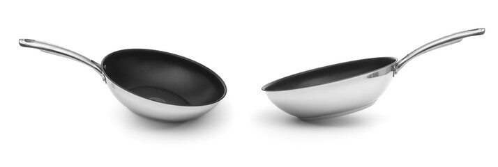 Two frying pans close up on a white background
