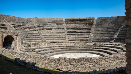 Ancient Roman Theatre of the ancient Roman city of Pompeii, buried by the eruption of Mount Vesuvius in 79 AD, with Mount Vesuvius visible in the distance, Italy