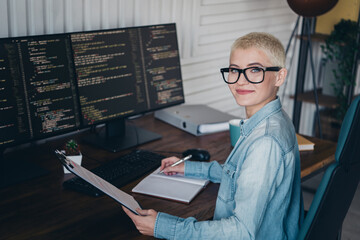 Professional young woman in modern home office working on coding projects