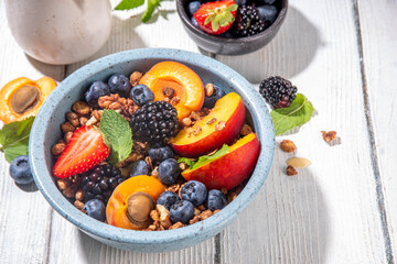 Granola breakfast with fruit and berry