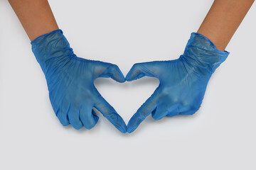 heart sign with hands in medical rubber gloves, sign of support and love from health workers