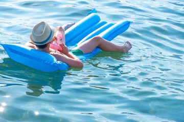 happy child basking in stylish hat and sunglasses enjoys luxurious beach day, young boy leisurely...