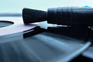 Carbon fiber brush gently cleans a vinyl record, preserving sound quality and extending the life of vintage audio equipment