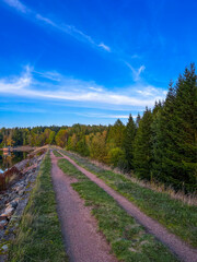 Landscape of gravel road in countryside with meadow. Road in rainy season. Side view of dirt road in forest. road background.