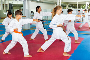 Young teenagers happy to attend karate class on self-defense