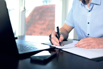 online meeting, man sitting in front of laptop and talking with team members