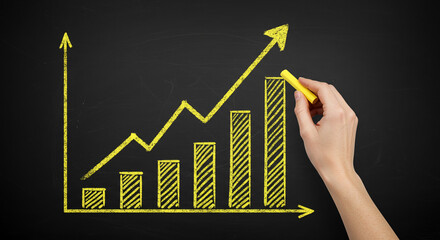 Hand Drawing Upward Trending Bar Graph on Chalkboard Growth Success Business Concept