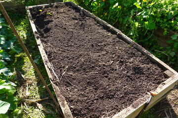Raised garden bed filled with fertile soil and organic compost