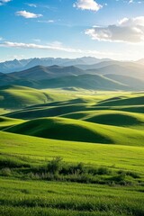 Obraz premium arafed view of a green field with mountains in the distance