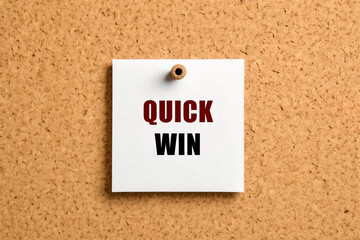 Quick win text on post-it paper pinned on the bulletin cork board