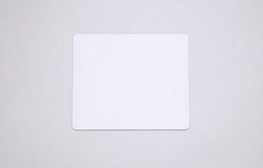 Mockup of white blank computer mouse pad or mat on gray background