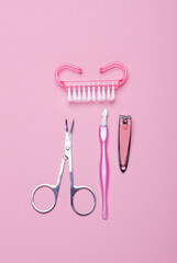 Nail care tools, manicure set on pink background. Flat lay. Top view