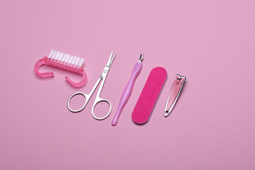 Nail care tools, manicure set on pink background. Flat lay. Top view