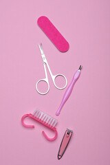 Nail care tools, manicure set on pink background. Flat lay. Top view