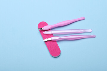 Nail care tools, manicure set on blue background. Flat lay. Top view