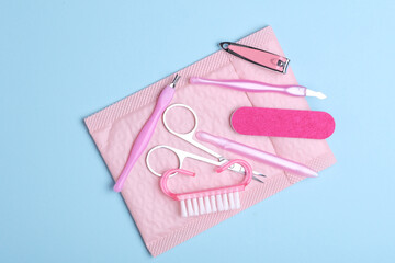 Nail care tools, manicure set on blue background. Flat lay. Top view