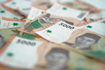 stack of five thousand rupiah banknotes, Indonesian money. suitable for background, finance, banking, cash, savings.