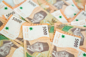stack of five thousand rupiah banknotes, Indonesian money. suitable for background, finance, banking, cash, savings.