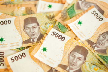 stack of five thousand rupiah banknotes, Indonesian money. suitable for background, finance, banking, cash, savings.