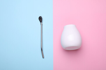 Calabash with bombilla for mate on blue and pink background