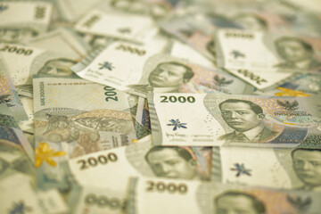A stack of two thousand rupiah banknotes, Indonesian money. suitable for background, finance, banking, cash, savings.