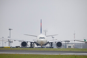 Passenger airplane standing on runway of airport getting ready to take off