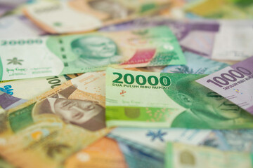 Various stacks of Indonesian banknotes, from one thousand rupiah to twenty thousand rupiah. Suitable for background, finance, banking, cash, savings.