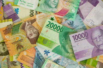 Various stacks of Indonesian banknotes, from one thousand rupiah to twenty thousand rupiah. Suitable for background, finance, banking, cash, savings.
