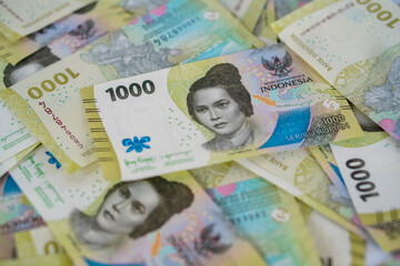 A stack of thousand rupiah banknotes, Indonesian money. suitable for background, finance, banking, cash, savings.