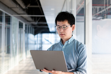 asian businessman working on laptop