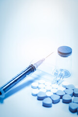Medical Supplies: Syringe, Vial, and Pills on Clean Background