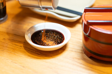 Soy Sauce with Chili Flakes in Japanese Dining Setting
