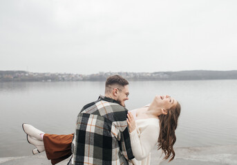 Fototapeta premium Smile with braces. Beautiful girl with braces on a date. Young people dancing, kissing and hugging, enjoying the meeting