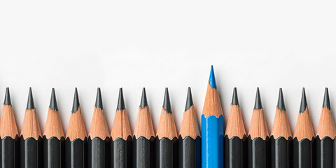 A single blue pencil standing out among a row of black pencils,  leadership, and unique ideas.