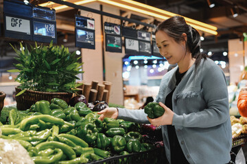 Vibrant Grocery Shopping Experience with Fresh Green Peppers