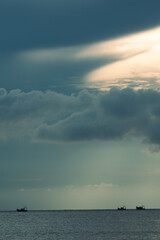 The calm before the storm — fishing boats drift beneath brooding skies as the sun slices through the clouds over the Arabian Sea. Shot in Goa, where the ocean meets poetry.
